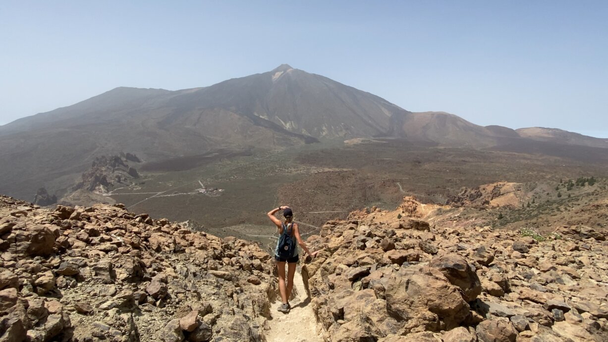 Osoba stojąca na punkcie widokowym w Parku Narodowym Teide z panoramą wulkanu Teide w tle – trudny szlak trekkingowy na Teneryfie.